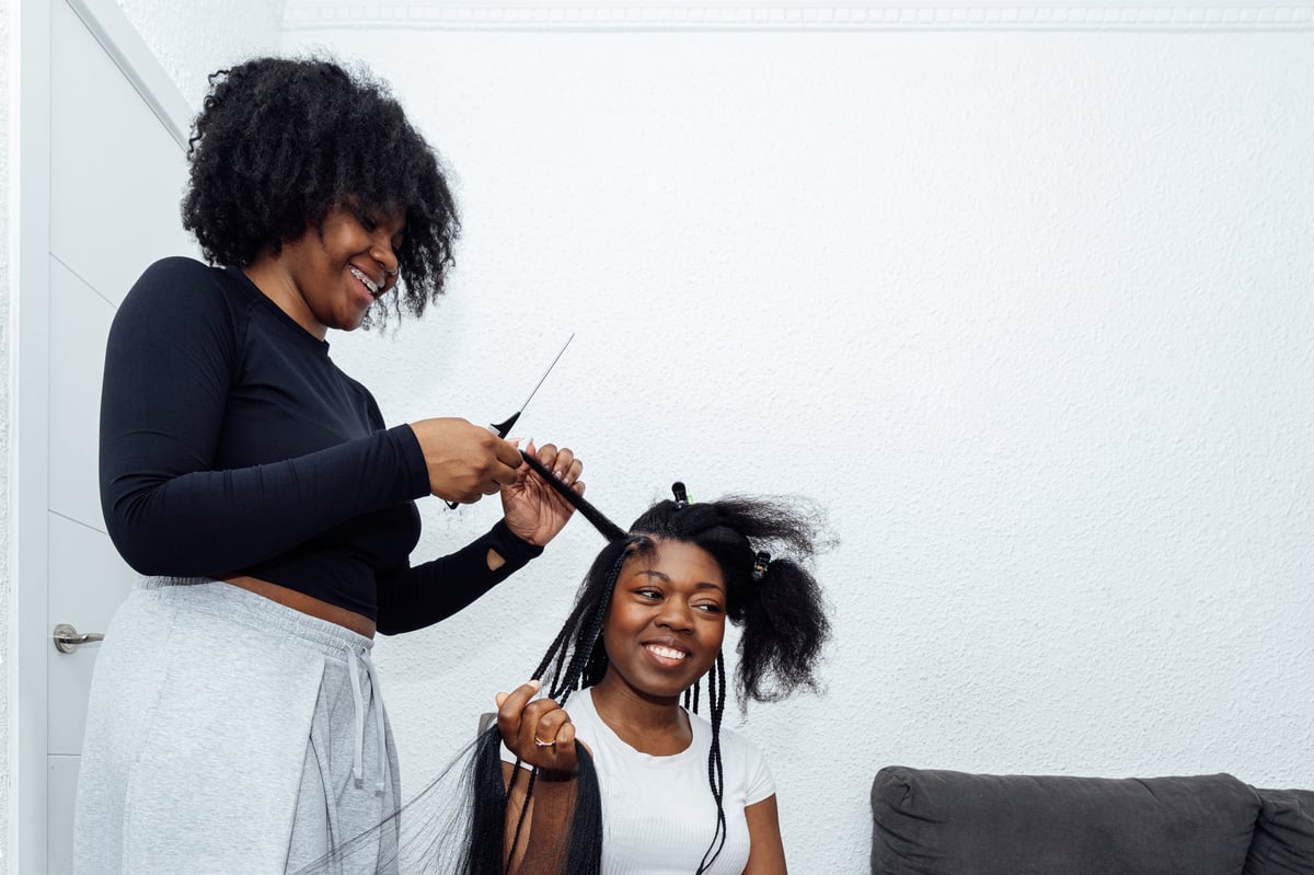 Woman having her hair braided at a salon in Crystal, Minnesota